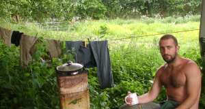 Mark Boyle (Moneyless Man) with a cup of tea, outside his caravan Date 